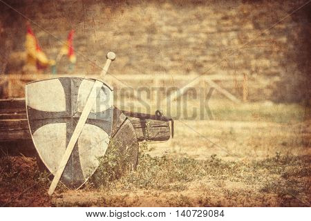 photo of the old sword and shield on the castle background