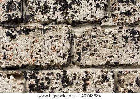 Wall made of concrete blocks stained black resin
