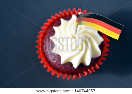 German National Day cupcake with german (black red and yellow) flag. The Day of German Unity. Focus on the flag.