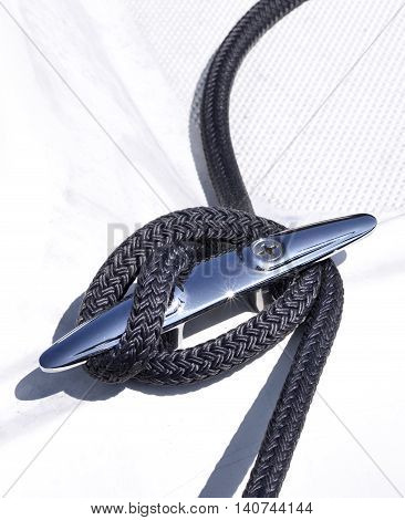 Anchored boat. Close-up of a moored motorboat or sailing ship. Rope fixed on a yacht.