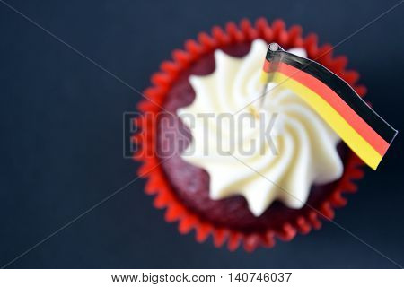 German National Day cupcake with german (black red and yellow) flag. The Day of German Unity. Focus on the flag.