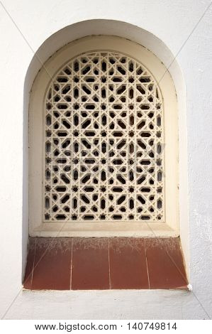 Arabic style pattern antique arch window on a white wall in Roc de Sant Gaieta Tarragona Spain.