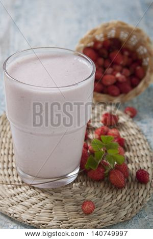 Smoothies with fresh strawberry with yogurt on a wooden table.
