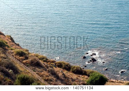 Clear blue sea breaking on the rocks