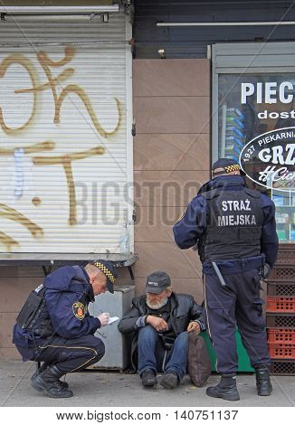 Warsaw, Poland - October 24, 2015: police officers are checking some strange man outdoor in Warsaw, Poland