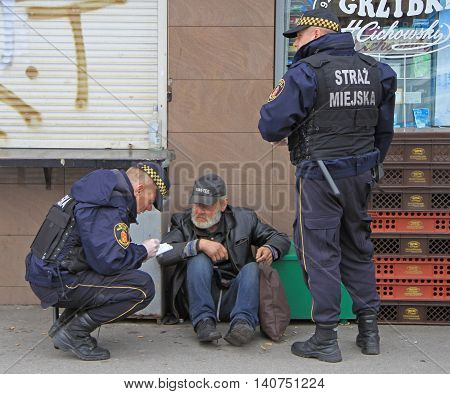 Warsaw, Poland - October 24, 2015: police officers are checking some strange man outdoor in Warsaw, Poland