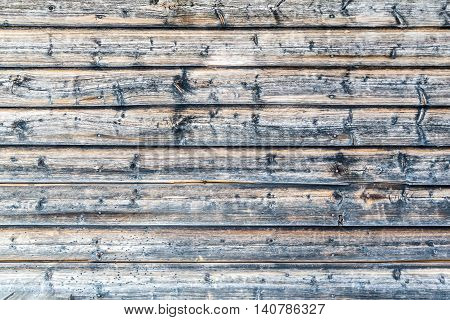 Close up of old worn log house wall outdoors.