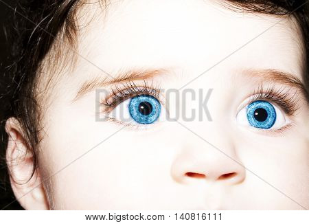 Macro Close up portrait of a cute little baby girls with blue eyes