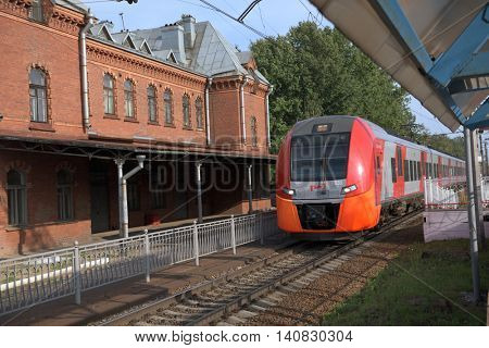 ST. PETERSBURG, RUSSIA - JULY 25, 2016: High-speed train Lastochka passes the station Shuvalovo. Produced by Siemens AG, the train can reach speeds up to 160 km/h