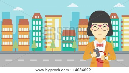 An asian young woman holding a smartphone looking at her smart watch. Concept of synchronization between smartwatch and smartphone. Vector flat design illustration. Horizontal layout.