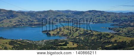 Akaroa Harbour and mountains. Landscape on the Banks Peninsula New Zealand. Bay town farmland and mountains.