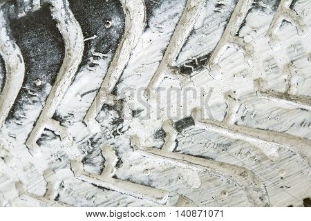 Old black tire with white paint in gruge style