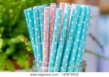 Colorful paper straws for birthday party on natural background