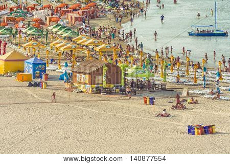 Mamaia Romania - July 18 2016:Group of tourists enjoying on beach in MamaiaMamaia is the best known resort on Romanian Riviera.It's situated on 8km long and 300m wide sandy land at the Black Sea.