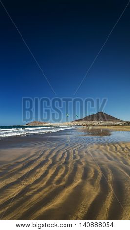la tejita kite surfing beach and montana roja landmark in south tenerife spain