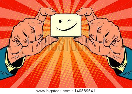 wink face in hands, pop art retro vector illustration