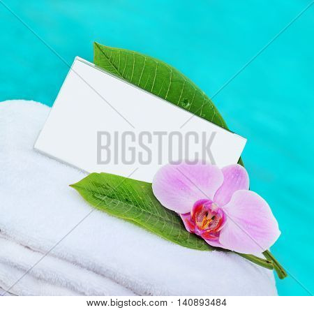 card with space for text and orchid on towel