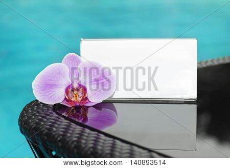 card with space for text and orchid on black table
