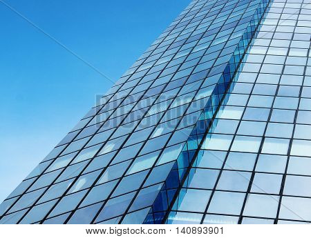 windows of modern skyscraper building with sky reflection
