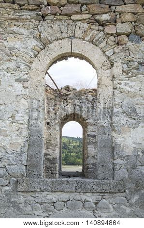 Old stone arc window in the window ruin of church Bulgaria Europe