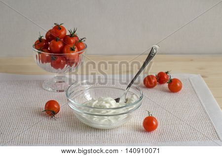 Breakfast with tomatoes and sour cream dill on a light background