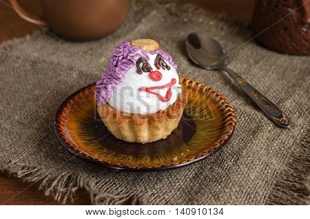 Tea and cake on a plate on a napkin of burlap