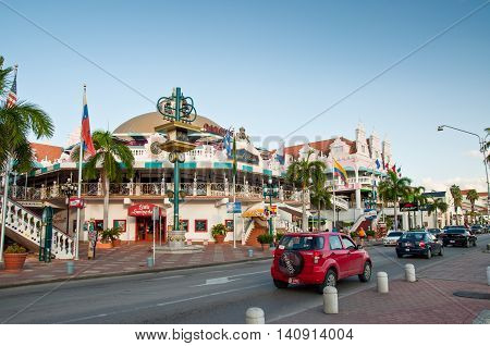 Oranjestad Aruba - December 1 2011: On Main Street Oranjestad stands a colorful mall containing shops and restaurants. Tourists can be seen entering the mall.