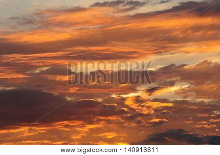 Sunrise intense yellow in the clouds of a storm