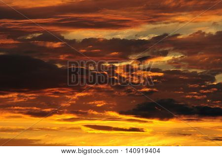 Sunrise intense yellow in the clouds of a storm