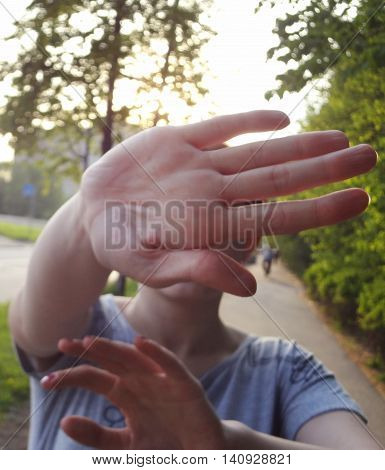 Not shoot sign by hand. Woman pop up palm not allowing to shoot her face