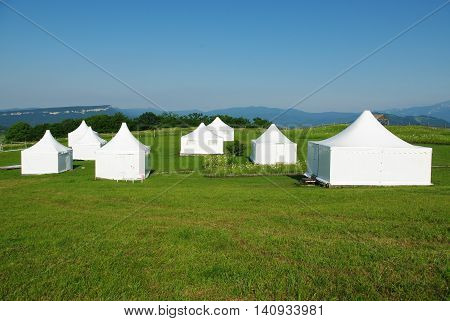 White tent on the green grass during the day