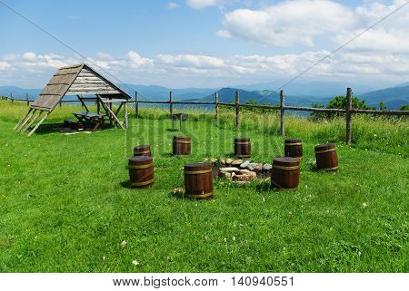 Stumps for seats in the Caucasus Mountains and gazebo