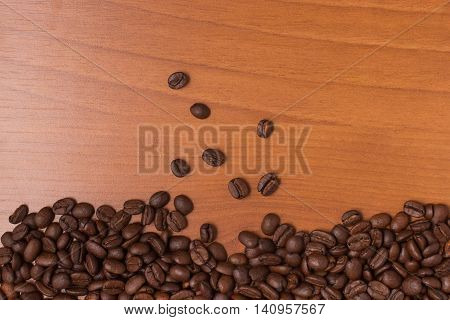 Coffee Beans Frame over a wooden table. Coffea arabica.