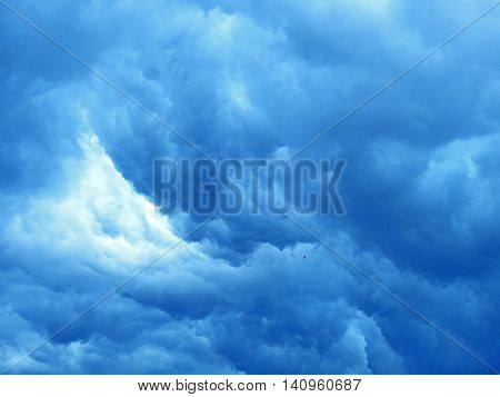 Massive dark blue clouds on sky before storm.