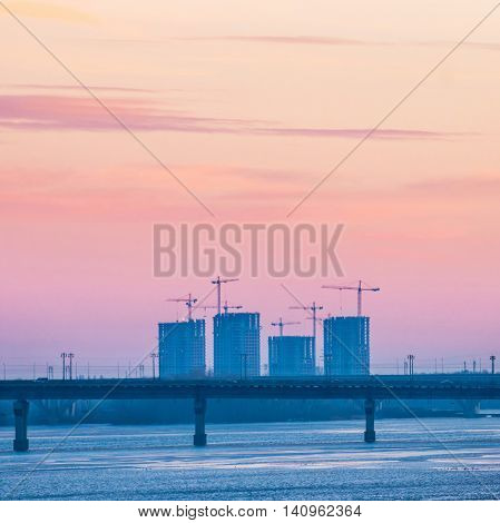 Spectacular sunset city view with bridge over Dnepr river. Kiev Ukraine