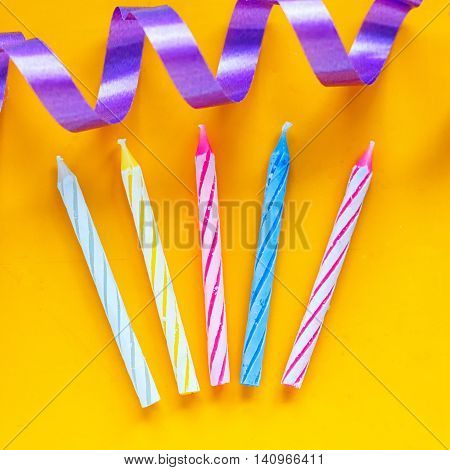 Candles and streamer on a yellow background