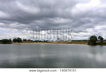 Photo of a beautiful cloudy sky and the lake with the church