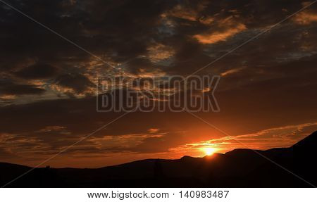 Orange sunrise in Austria mountains in summer time in village Maiersdorf