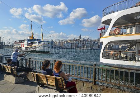 Istanbul Turkey - July 26 2016: Galata Bridge Galata Tower Ferry Istanbul Views. This is a great place to see the colors of Istanbul at . Interesting to see the fishermen on the bridge with the Galata tower in the background. There are lots of restaurants