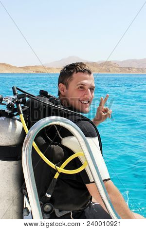 Happy Young Diver In A Suit For Diving Is Preparing To Dive.