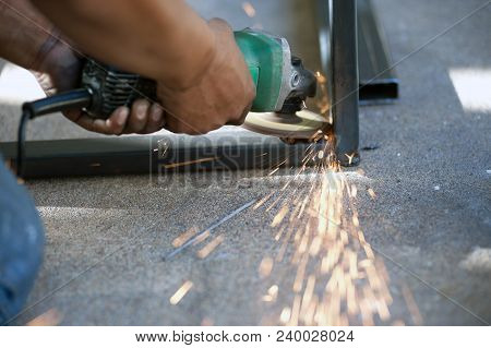 The Worker Is Welding Metal Part Of Table Steel In Factory.