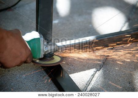 The Worker Is Welding Metal Part Of Table Steel In Factory.
