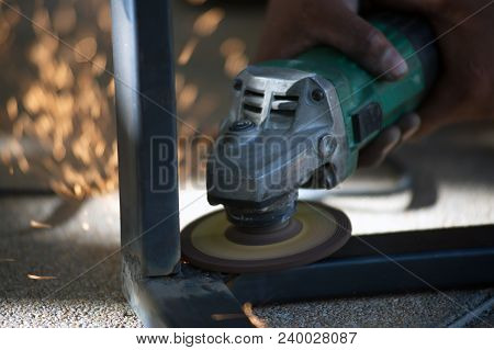 The Worker Is Welding Metal Part Of Table Steel In Factory.
