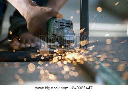 The Worker Is Welding Metal Part Of Table Steel In Factory.