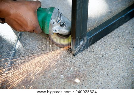 The Worker Is Welding Metal Part Of Table Steel In Factory.