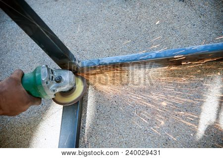 The Worker Is Welding Metal Part Of Table Steel In Factory.