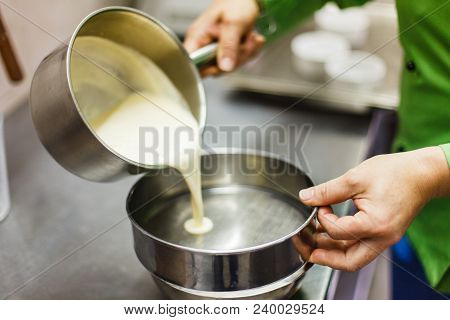 The Process Of Straining When Preparing The Brule Cream. Vanilla Pods On A Steel Sieve. Professional