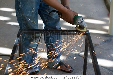 The Worker Is Welding Metal Part Of Table Steel In Factory.