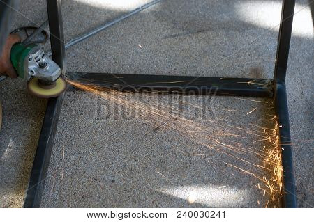 The Worker Is Welding Metal Part Of Table Steel In Factory.