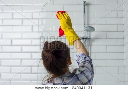 House Cleaning. Woman Is Cleaning In The Bathroom At Home